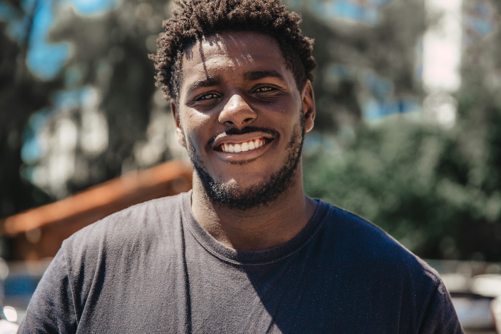 Portrait of a smiling Black man outdoors in natural light